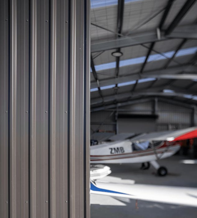 Hangar door with aircraft in background - Wide Span Sheds