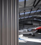 Hangar door with aircraft in background - Wide Span Sheds Hangar door with aircraft in background - Wide Span Sheds