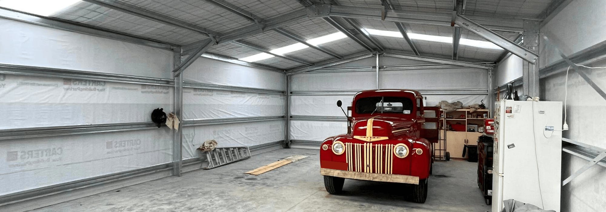 A classic vehicle in a Wide Span Shed