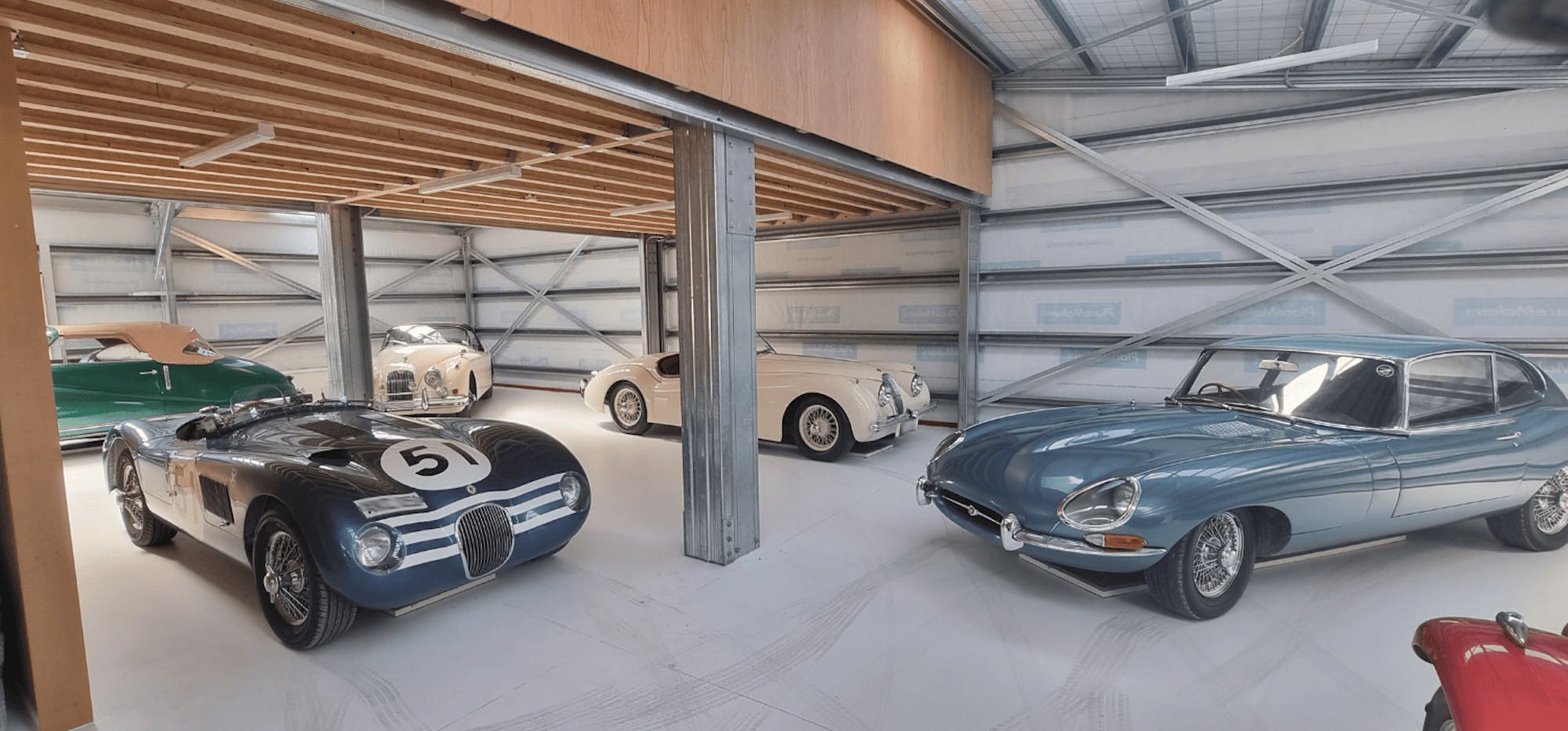 Pioneer Red Rural American Barn with classic vehicles inside