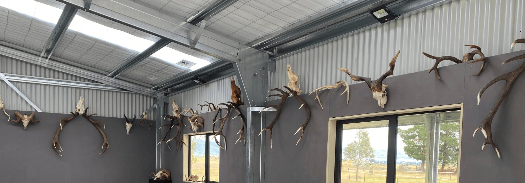 The Hunters Den steel shed project - Interior with antlers on wall